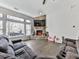 Bright living room featuring a stone fireplace, large windows, and comfortable seating arrangement, ideal for relaxation at 815 Commerce Trl, Canton, GA 30114