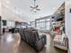Open concept living space with hardwood floors, a stone fireplace, and abundant natural light from numerous windows at 815 Commerce Trl, Canton, GA 30114