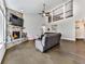 Open-concept living room with a stone fireplace, hardwood floors, and a view of the upper level loft at 815 Commerce Trl, Canton, GA 30114