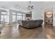 Spacious living room with hardwood floors, a cozy stone fireplace, and large windows offering scenic views at 815 Commerce Trl, Canton, GA 30114