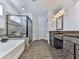 Primary bathroom with a glass enclosed shower, separate soaking tub, and a double sink vanity at 815 Commerce Trl, Canton, GA 30114