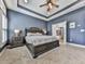 Primary bedroom featuring a trey ceiling, a ceiling fan, and an ornate king bed leading to the en suite at 815 Commerce Trl, Canton, GA 30114