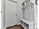 Entryway mudroom featuring a bench with storage, coat hooks, and a door to enter the house at 815 Commerce Trl, Canton, GA 30114
