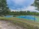 Well-maintained tennis courts surrounded by trees offer an active lifestyle at 815 Commerce Trl, Canton, GA 30114