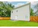 View of home's back exterior with access to the backyard and a wood privacy fence at 90 Cerro St, Atlanta, GA 30314