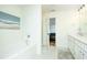 Bright bathroom with a white tub, white walls, and patterned flooring at 90 Cerro St, Atlanta, GA 30314