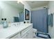 Bathroom with white cabinets and countertops, patterned floors, and a blue shower curtain at 90 Cerro St, Atlanta, GA 30314