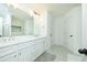 Bathroom with double sinks, a white countertop, and a patterned floor at 90 Cerro St, Atlanta, GA 30314