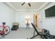 Bright bedroom with neutral carpet, ceiling fan, and weights at 90 Cerro St, Atlanta, GA 30314