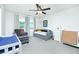 Bright bedroom with grey walls, a ceiling fan, and neutral carpet at 90 Cerro St, Atlanta, GA 30314