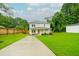 Charming two-story home features a well-manicured lawn, covered porch, and a cozy seating area at 90 Cerro St, Atlanta, GA 30314
