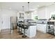 Modern kitchen features white cabinets, stainless steel appliances, and a center island at 90 Cerro St, Atlanta, GA 30314