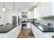 Bright kitchen with stainless appliances, white cabinets, and a center island with barstool seating at 90 Cerro St, Atlanta, GA 30314