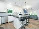 Modern kitchen with stainless steel appliances, white cabinets, and island with bar seating at 90 Cerro St, Atlanta, GA 30314