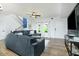 Open-concept living room has hardwood floors, staircase, and comfortable, modern furnishings at 90 Cerro St, Atlanta, GA 30314