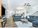 Open-concept living room boasts hardwood floors, ceiling fan, and access to the kitchen at 90 Cerro St, Atlanta, GA 30314