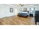 This spacious main bedroom has a tray ceiling with ceiling fan and wood-look laminate flooring at 90 Cerro St, Atlanta, GA 30314