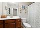 Bathroom featuring butterfly decorations and a shower-tub combo at 1427 Lanier Vista Dr, Sugar Hill, GA 30518
