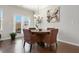 Bright dining area with a round wooden table, four chairs, and natural light from the patio doors at 1427 Lanier Vista Dr, Sugar Hill, GA 30518