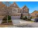 Beautiful brick townhome with an attached two car garage and landscaped yard at 1427 Lanier Vista Dr, Sugar Hill, GA 30518