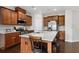 Beautiful kitchen boasts granite countertops, stainless steel appliances, and dark hardwood flooring at 1427 Lanier Vista Dr, Sugar Hill, GA 30518