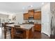 Kitchen featuring granite counters, stainless appliances, a breakfast bar and views to dining area at 1427 Lanier Vista Dr, Sugar Hill, GA 30518
