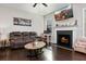 Relaxing living room with cozy fireplace, modern décor and plenty of natural light from bright windows at 1427 Lanier Vista Dr, Sugar Hill, GA 30518