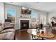 Bright living room with fireplace and mantle with views to windows and the beautiful neighborhood at 1427 Lanier Vista Dr, Sugar Hill, GA 30518
