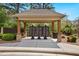 Mailboxes under a wooden pergola with stone and wood columns, surrounded by bushes at 1427 Lanier Vista Dr, Sugar Hill, GA 30518