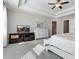 Main bedroom with tray ceiling, and furniture, including a television and dresser at 1427 Lanier Vista Dr, Sugar Hill, GA 30518