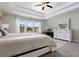 Spacious main bedroom has neutral decor, a tray ceiling, and a window view at 1427 Lanier Vista Dr, Sugar Hill, GA 30518