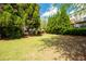 Large grassy backyard, perfect for entertaining and play with lush landscaping and mature trees at 2171 W Village Se Ln, Smyrna, GA 30080