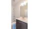 Bathroom with a vanity, sink, mirror, and a combined shower-tub at 2171 W Village Se Ln, Smyrna, GA 30080