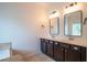 Elegant bathroom with double vanity, framed mirrors and tiled floors at 2171 W Village Se Ln, Smyrna, GA 30080