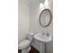 Cozy half-bathroom featuring classic pedestal sink, and an oval mirror at 2171 W Village Se Ln, Smyrna, GA 30080