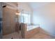 Elegant bathroom featuring tiled shower, soaking tub and tiled floors at 2171 W Village Se Ln, Smyrna, GA 30080