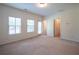 Large bedroom with carpet, dual windows, and access to a door at 2171 W Village Se Ln, Smyrna, GA 30080