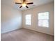 Spacious carpeted bedroom with dual windows and ceiling fan at 2171 W Village Se Ln, Smyrna, GA 30080