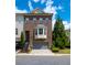 Brick townhome boasts a two-car garage and manicured landscaping, creating an inviting curb appeal at 2171 W Village Se Ln, Smyrna, GA 30080