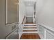 Inviting foyer showcasing hardwood floors, staircase, and elegant wainscoting at 2171 W Village Se Ln, Smyrna, GA 30080