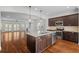 Open kitchen with a center island, stainless steel appliances, and hardwood flooring at 2171 W Village Se Ln, Smyrna, GA 30080