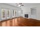 Bright living room with hardwood floors, fireplace, and access to outdoor deck at 2171 W Village Se Ln, Smyrna, GA 30080