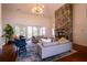 Vaulted living room with a stone fireplace and large windows bringing in natural light at 2171 W Village Se Ln, Smyrna, GA 30080
