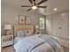 Bedroom with neutral decor features a ceiling fan, light hardwood floors, and ensuite closet at 2637 Crestdale Se Cir, Atlanta, GA 30316