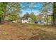 View of a two-story home with gray siding surrounded by lush trees at 2637 Crestdale Se Cir, Atlanta, GA 30316