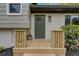 Inviting front door with brick accents, a decorative light fixture, and manicured landscaping at 2637 Crestdale Se Cir, Atlanta, GA 30316