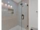 Modern tiled shower with glass door and built in plant nook at 2637 Crestdale Se Cir, Atlanta, GA 30316