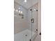 Modern glass enclosed walk in shower with gray subway tile surround and marble tiled floor at 2637 Crestdale Se Cir, Atlanta, GA 30316