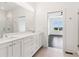 A modern bathroom offers a double sink vanity with quartz countertop and a glass shower at 443 Plateau Nw Pl, Atlanta, GA 30309