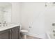 Clean bathroom featuring a modern vanity, a toilet and a shower-bathtub combination with white tiles at 443 Plateau Nw Pl, Atlanta, GA 30309